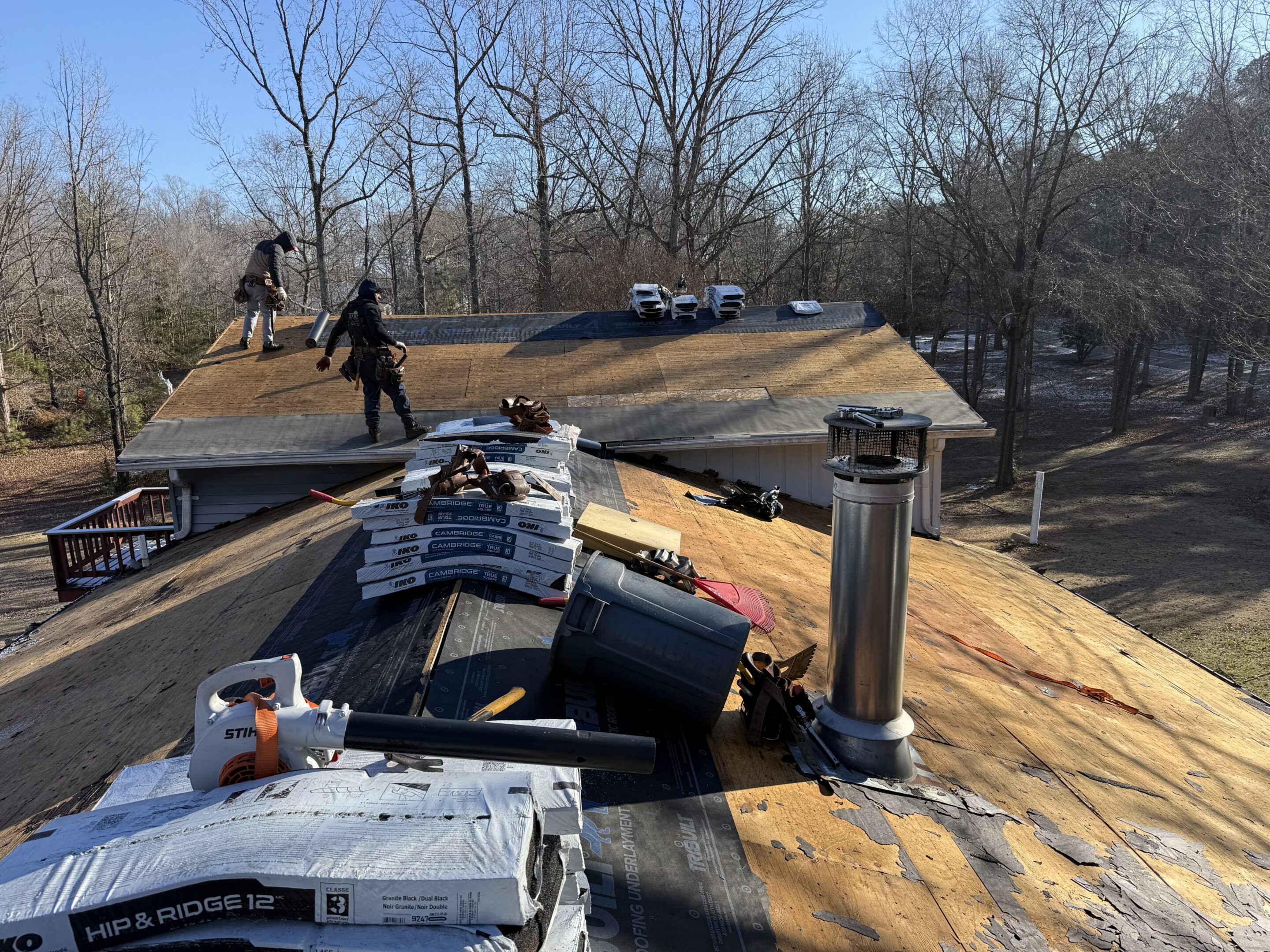 Roofers working on house under construction.