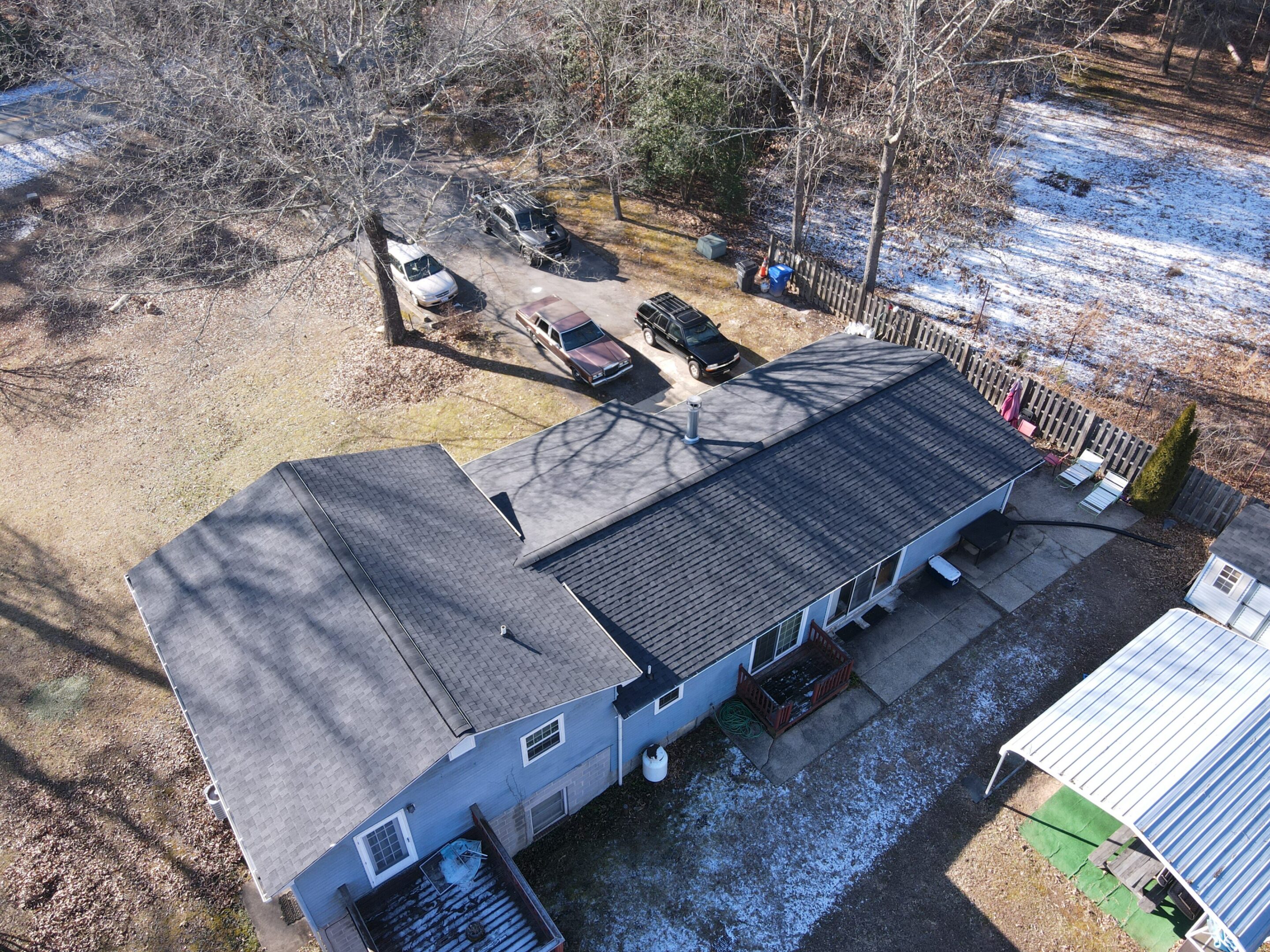 Aerial view of house with snowy yard.