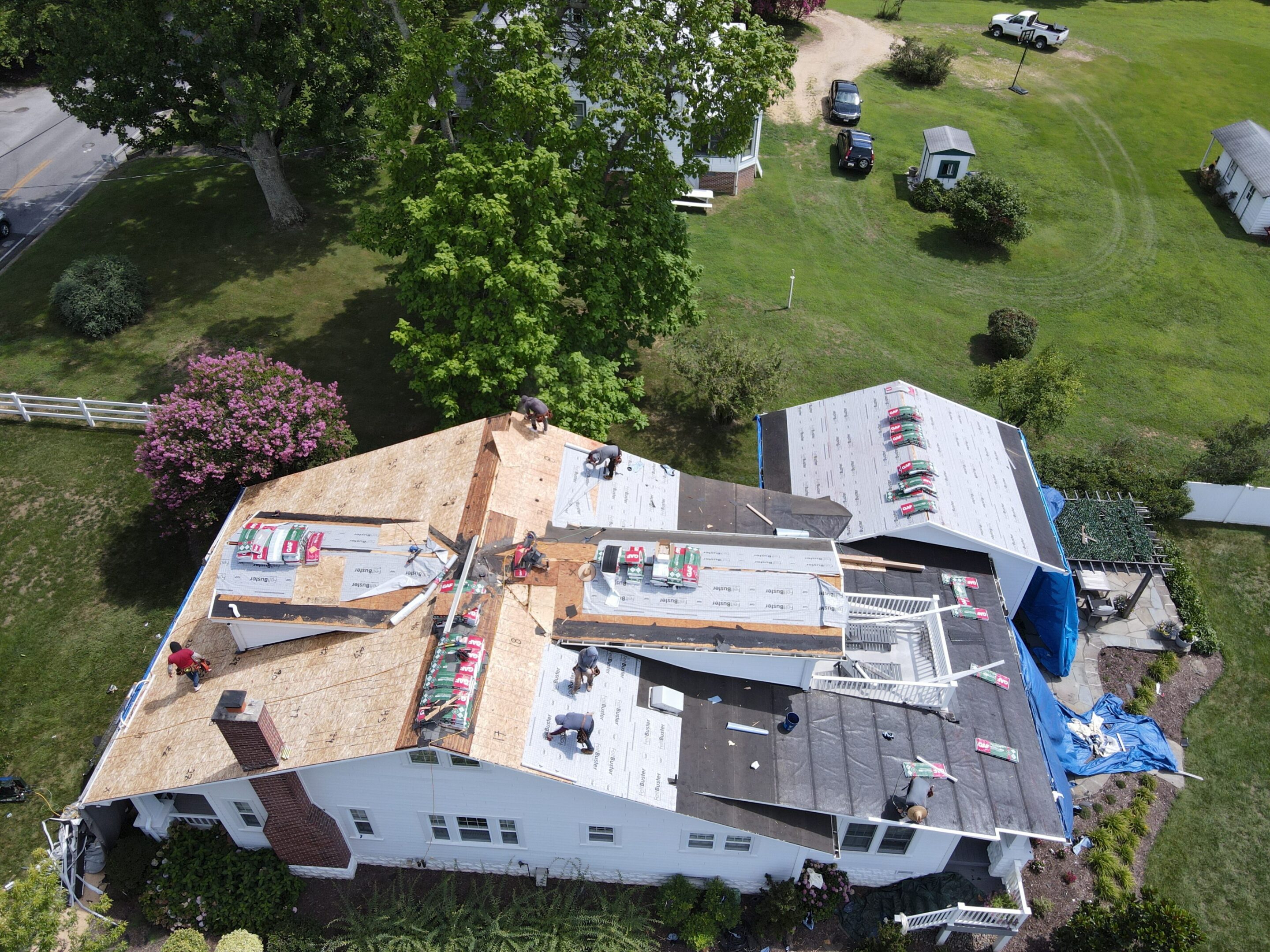 Roof renovation on a suburban house, aerial view.
